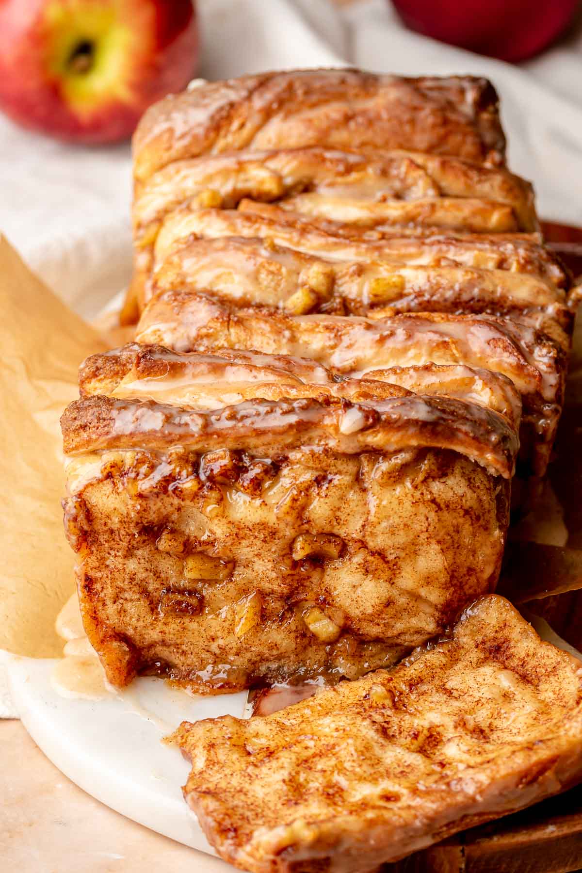 Baked apple fritter pull apart bread with a piece removed.