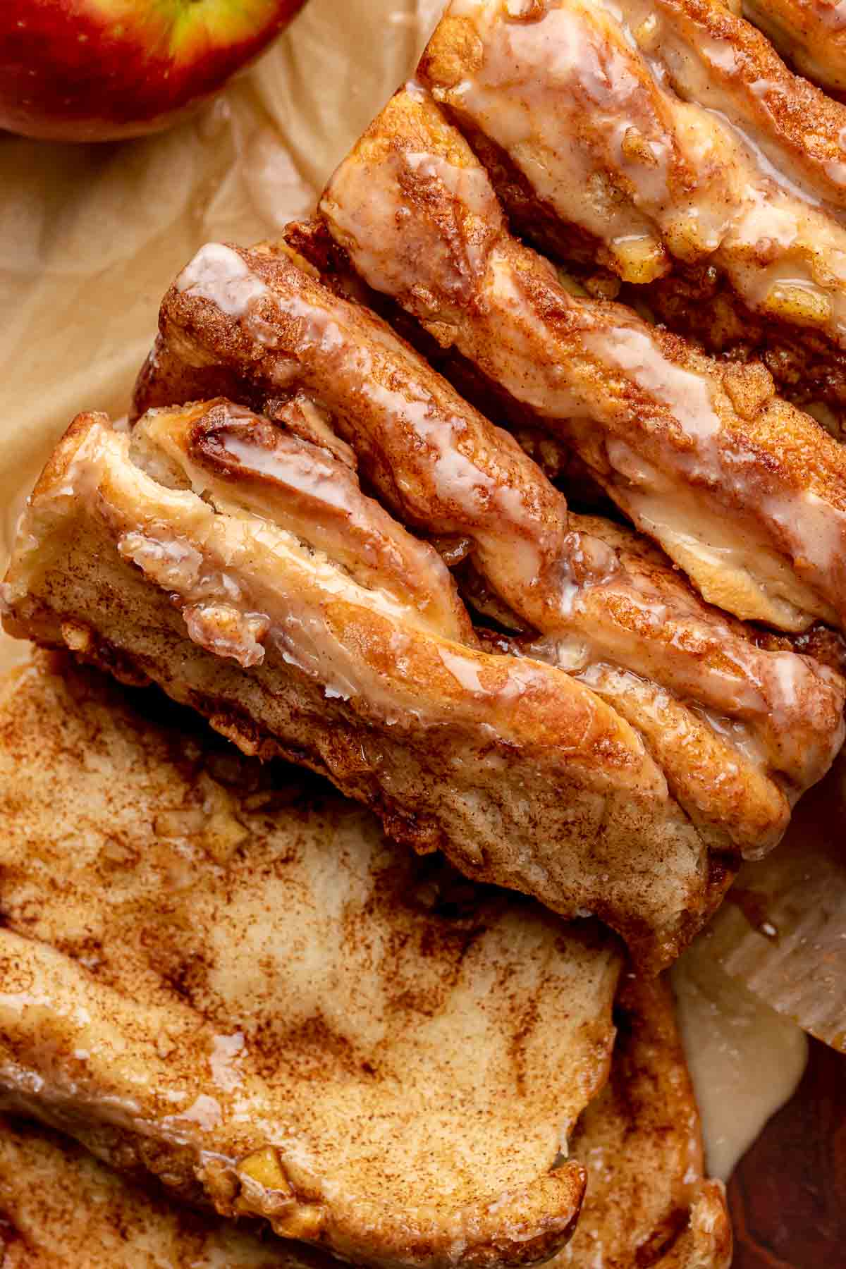 Baked apple fritter pull apart bread with a piece removed.
