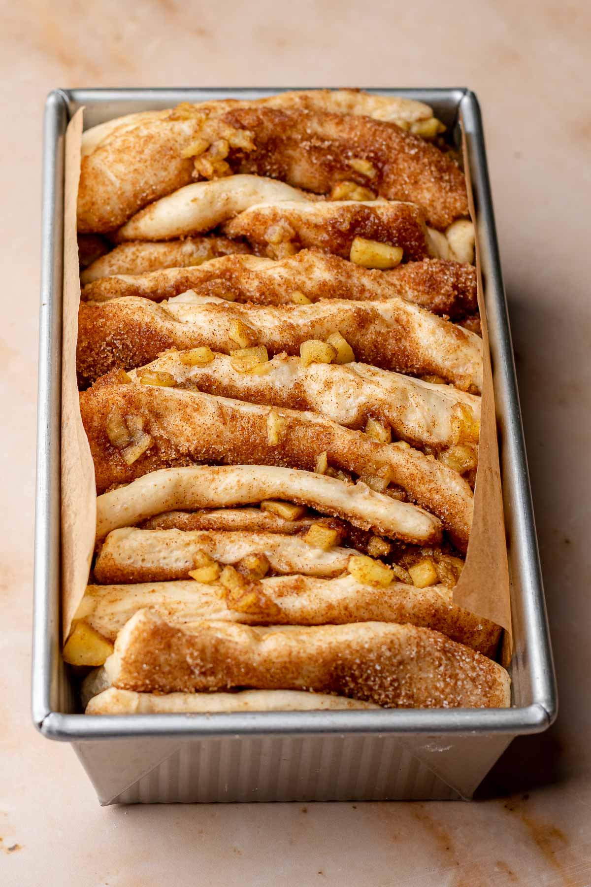 Pull apart bread in a loaf pan after rising, before baking.