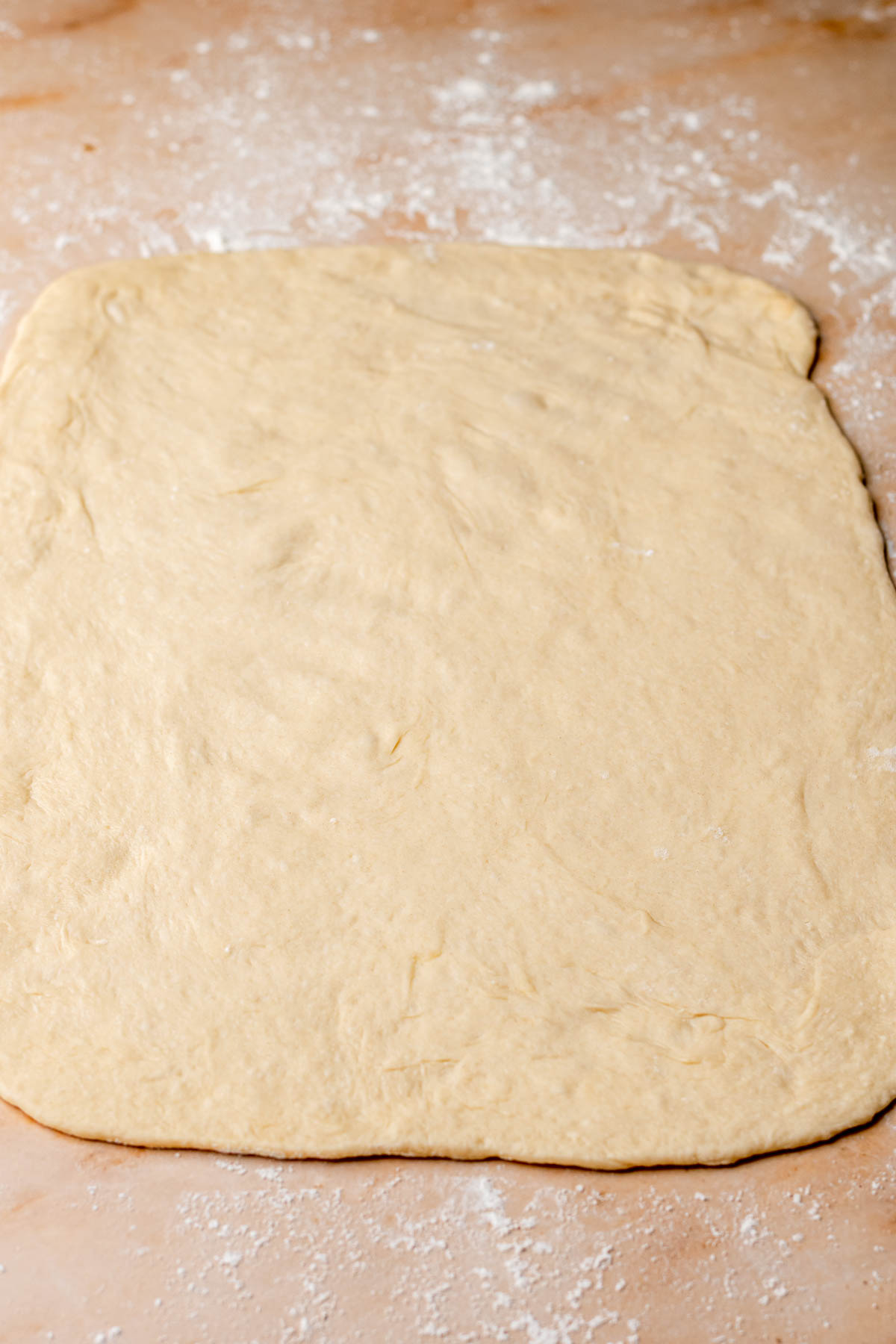 Dough rolled into a large rectangle on the counter.