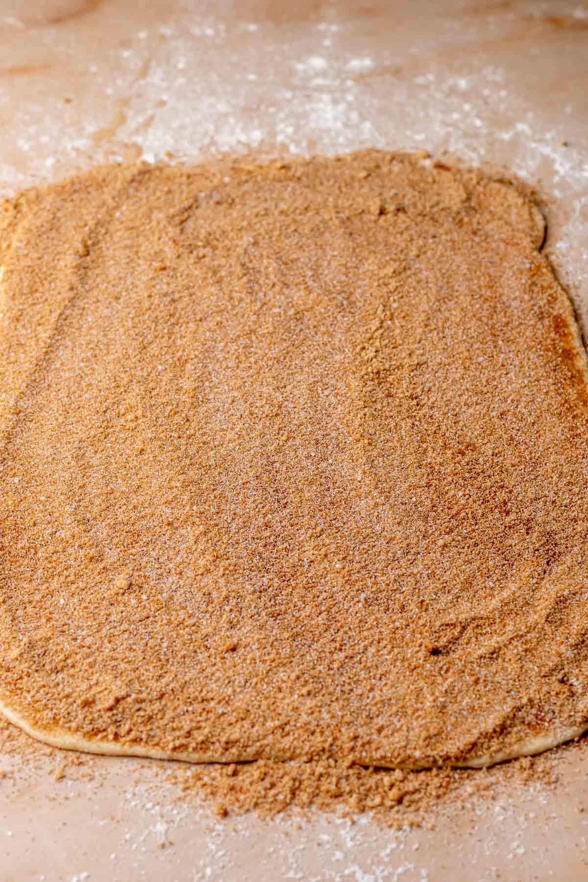 Cinnamon sugar all over the rolled dough.