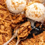 Biscoff pazookie with ice cream on top and cookie scooped onto a spoon.
