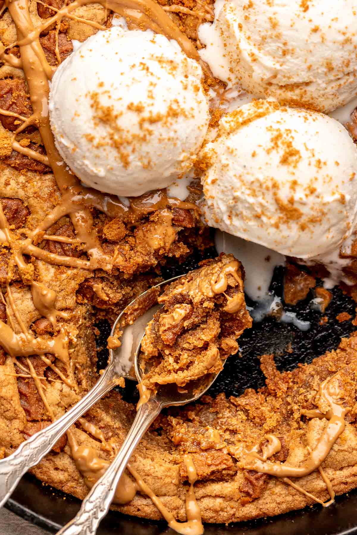 Biscoff pazookie with ice cream on top and cookie scooped onto a spoon.
