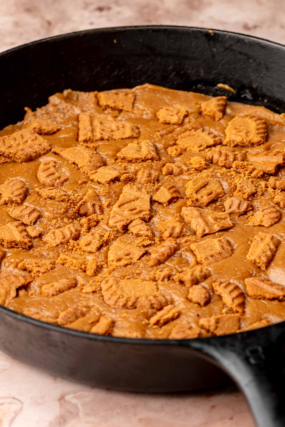 Skillet cookie with biscoff cookie pieces pressed into it.