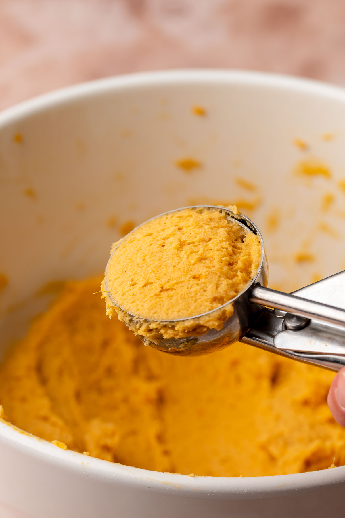 A flush scoop of cookie dough in a cookie scoop.