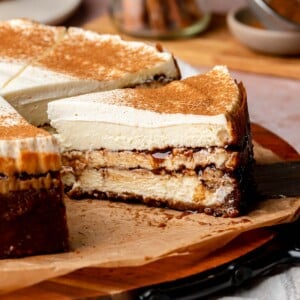 Sliced cinnamon roll cheesecake on a platter.