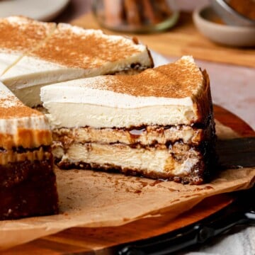 Sliced cinnamon roll cheesecake on a platter.
