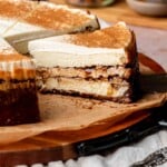Sliced cinnamon roll cheesecake on a platter.