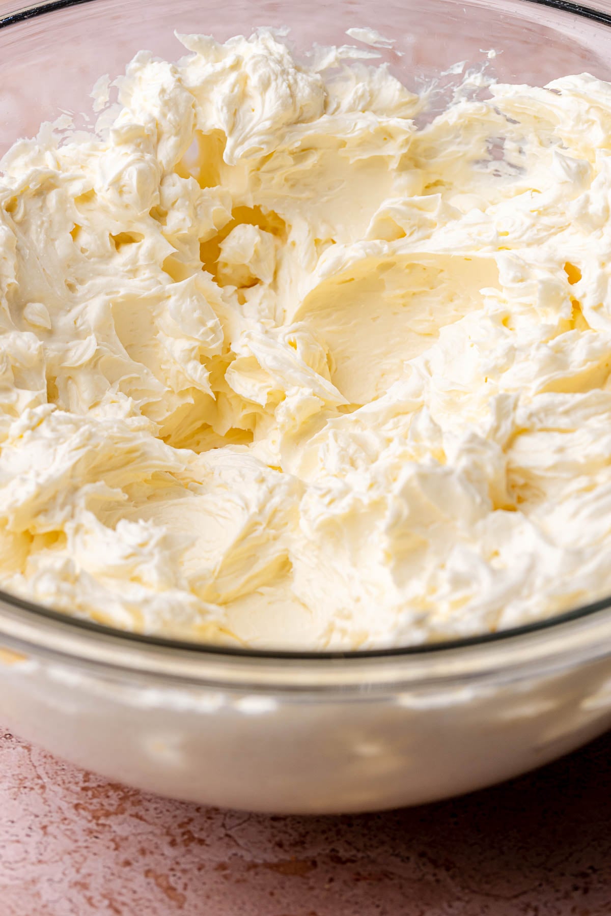 Cream cheese beaten in a bowl.