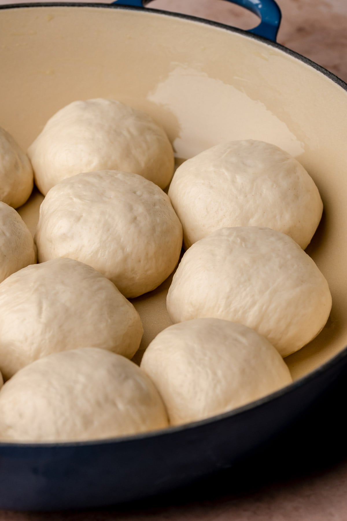 Pizza bites nestled into a baking dish before baking.